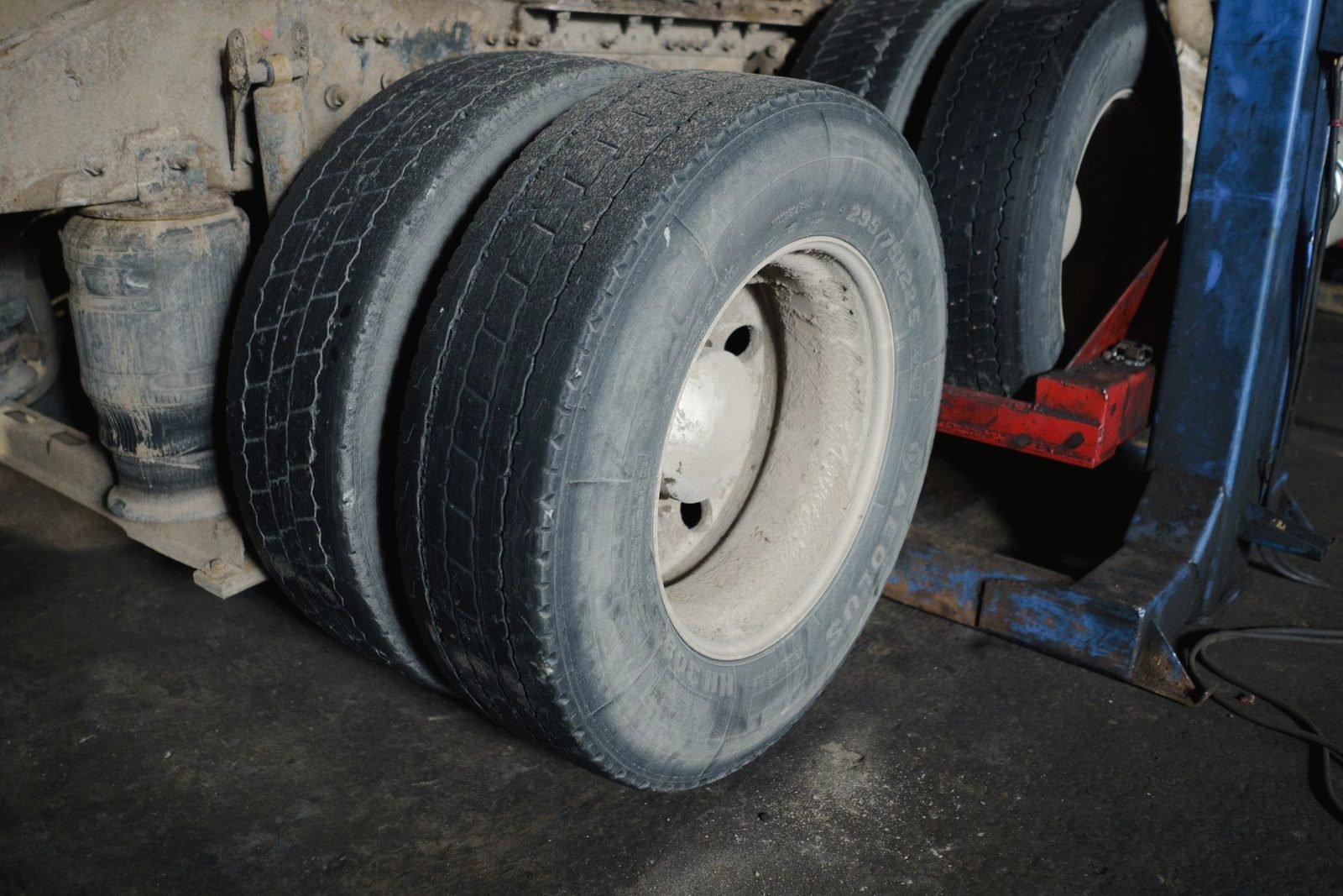 Worn dual tires on a truck in a shop